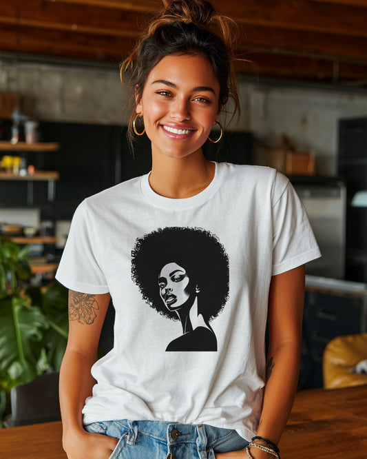 Woman wearing a white t-shirt with a black graphic of a woman with an afro in a casual setting.