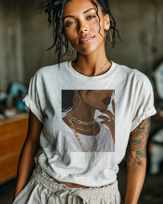 Woman wearing a white t-shirt with a graphic design of a woman with a gold chain necklace.