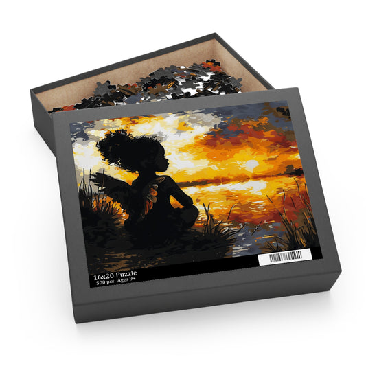 Jigsaw puzzle box with a sunset design featuring a silhouette of a Black child as an angel.